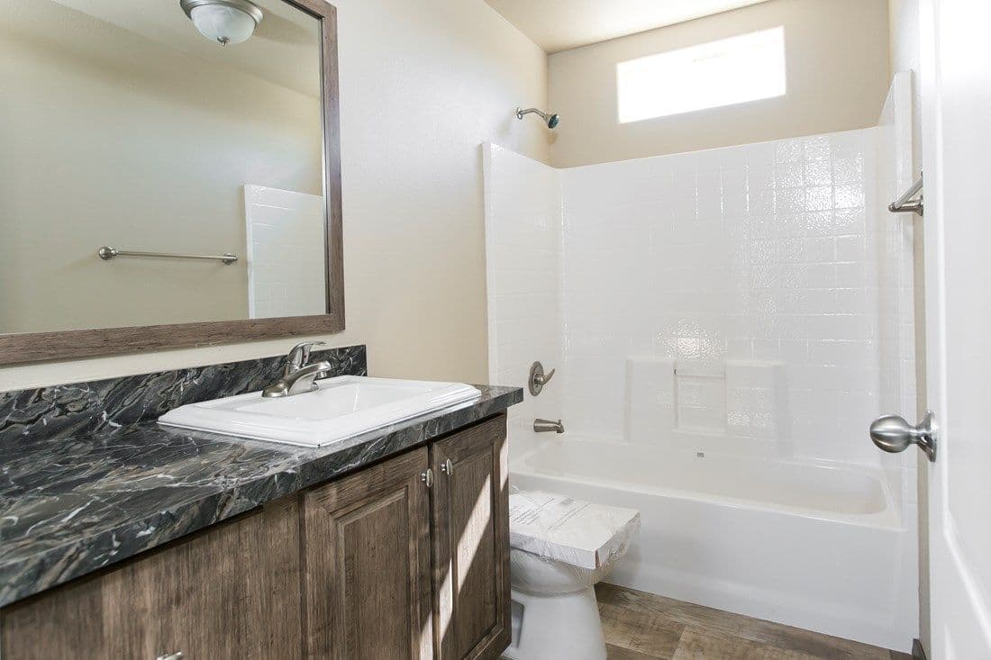 The 2022 COLUMBIA RIVER (NEW) Guest Bathroom. This Manufactured Mobile Home features 3 bedrooms and 2 baths.