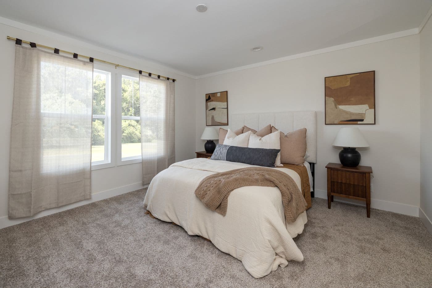 The LET IT BE Primary Bedroom. This Manufactured Mobile Home features 3 bedrooms and 2 baths.