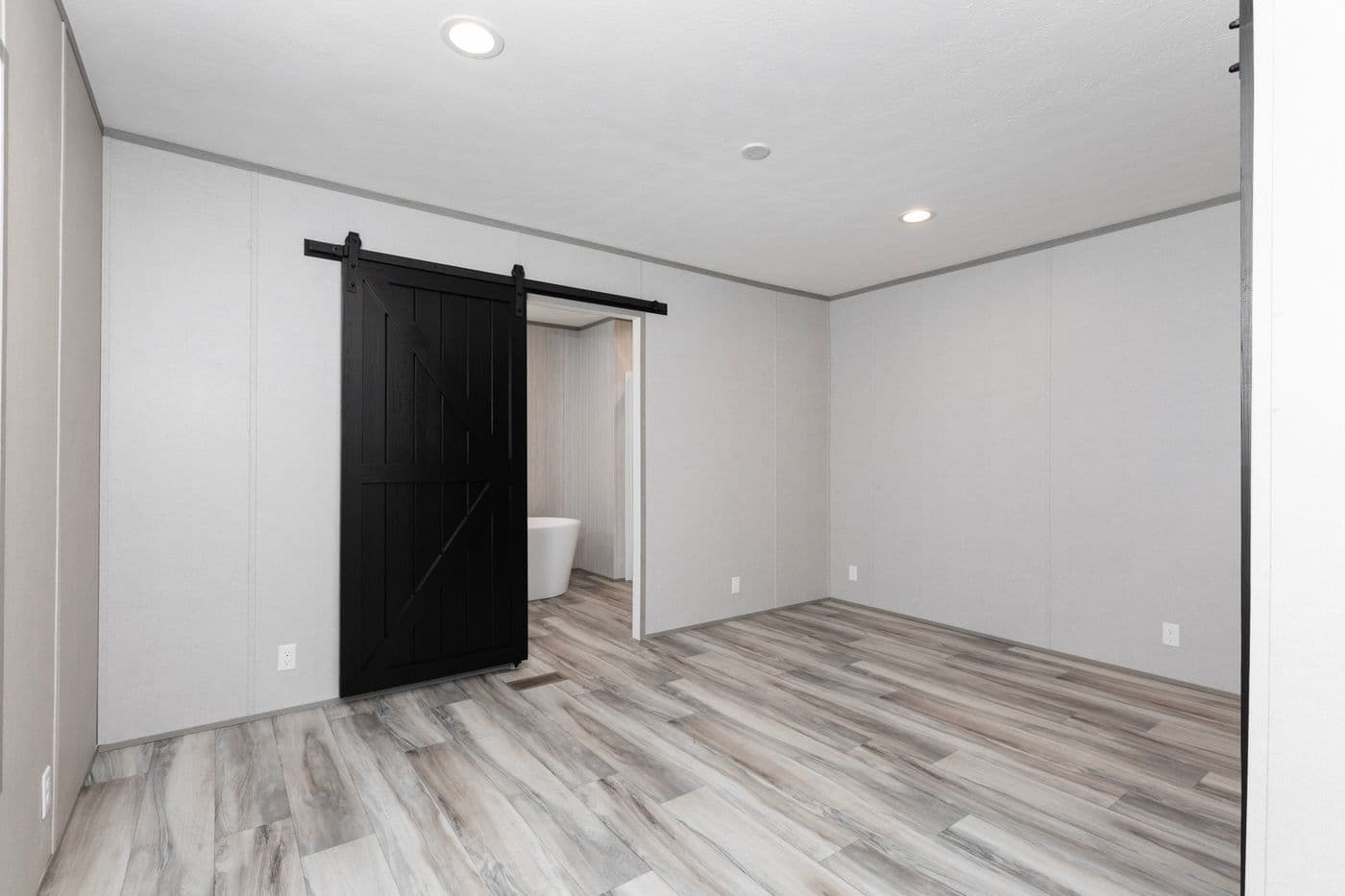 The THE OLYMPUS Primary Bedroom. This Manufactured Mobile Home features 3 bedrooms and 2 baths.