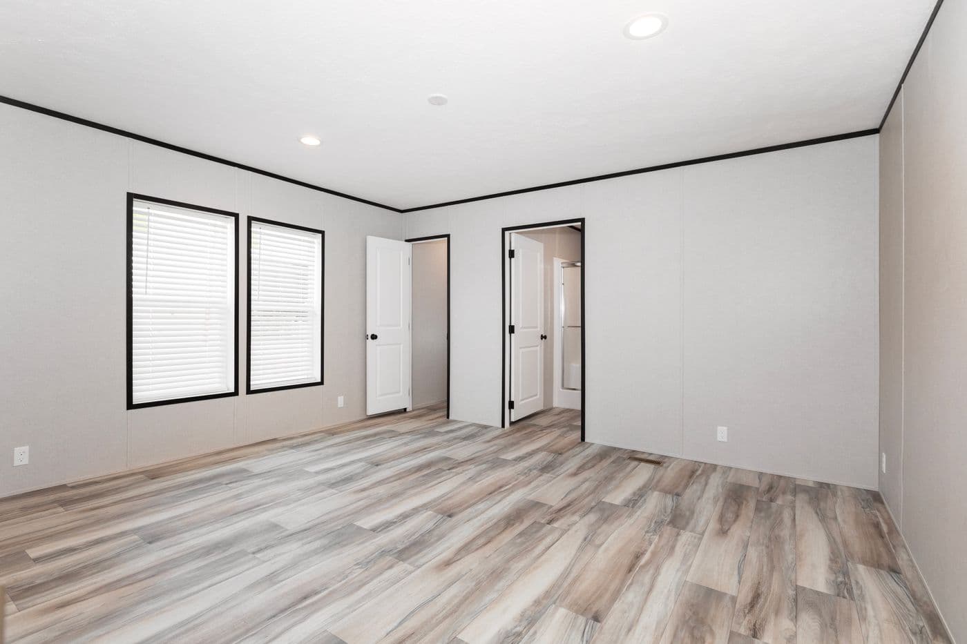 The THE FUJI Primary Bedroom. This Manufactured Mobile Home features 3 bedrooms and 2 baths.