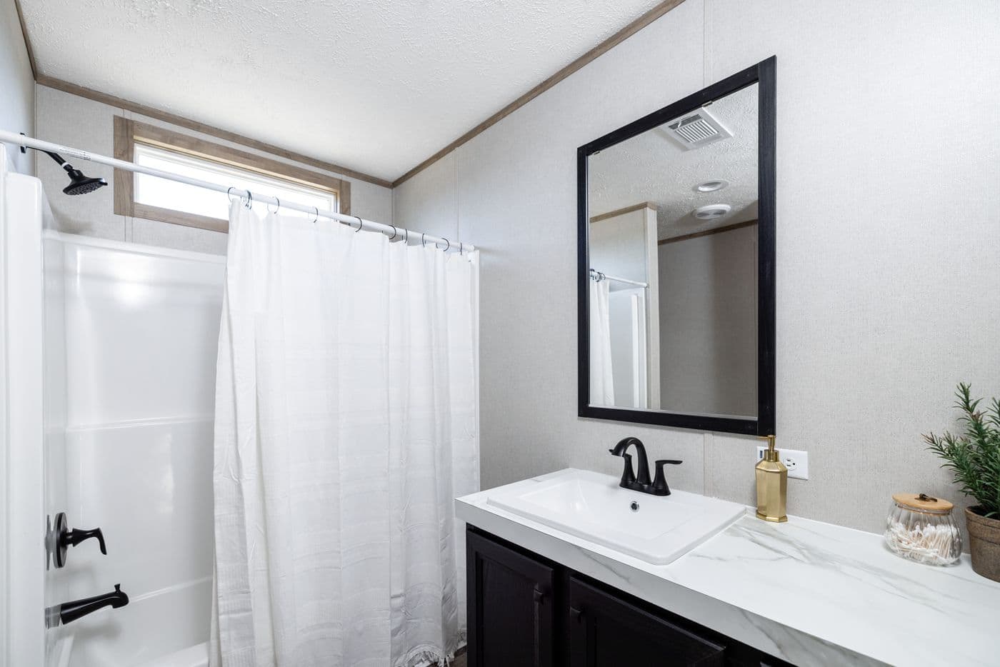 The STERLING ANNIVERSARY Guest Bathroom. This Manufactured Mobile Home features 3 bedrooms and 2 baths.