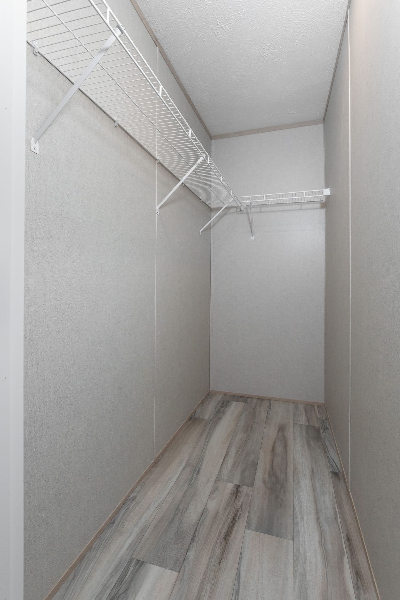The THE ANNIVERSARY ISLANDER Primary Bedroom. This Manufactured Mobile Home features 3 bedrooms and 2 baths.