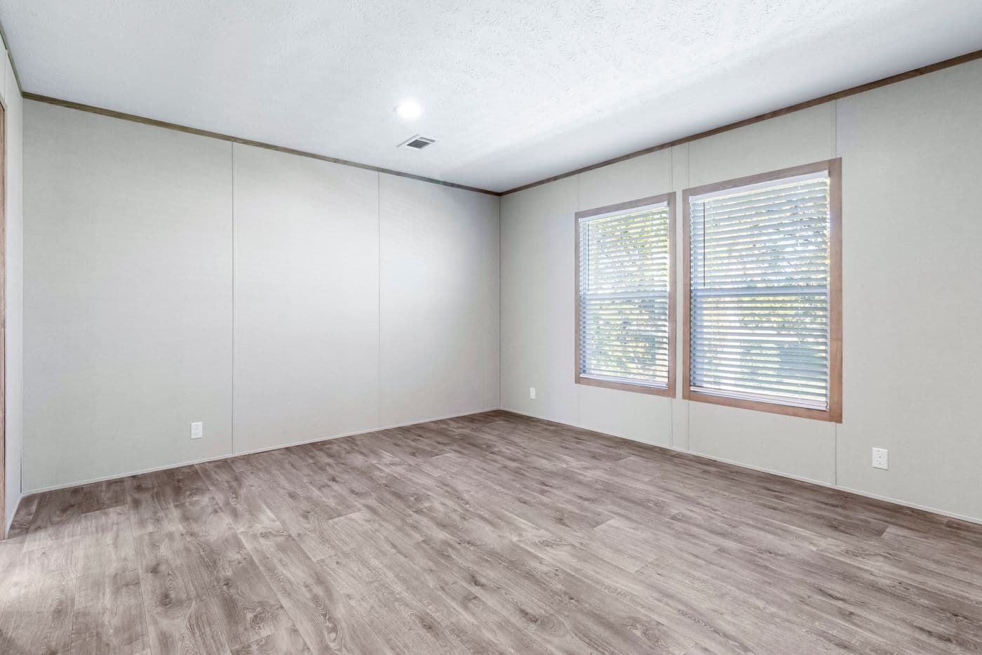 The THE BIG DEAL 52 Primary Bedroom. This Manufactured Mobile Home features 3 bedrooms and 2 baths.