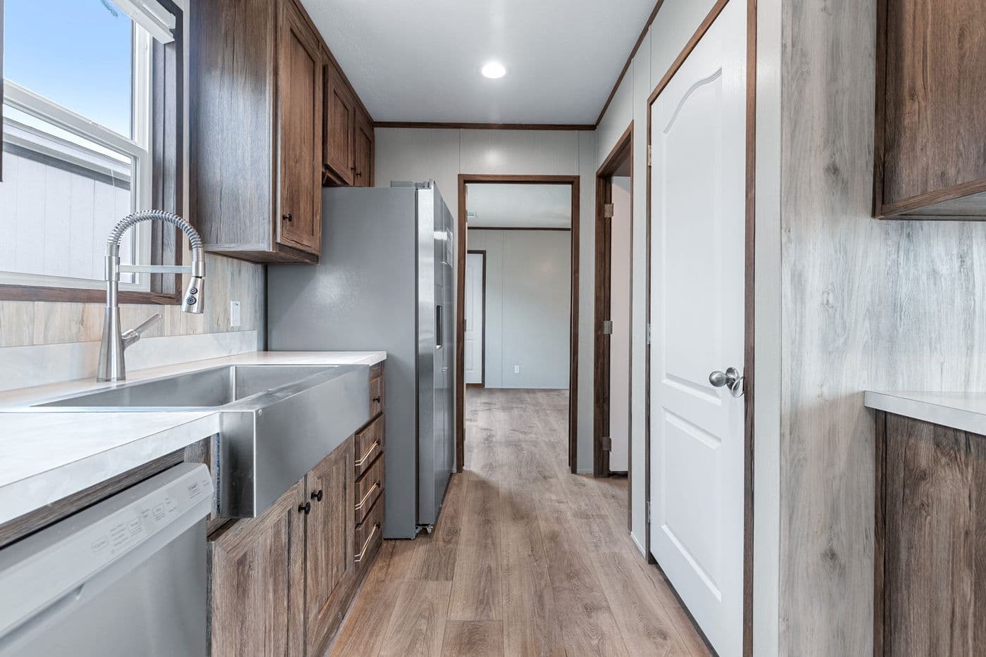 The ANNIVERSARY 16683B Kitchen. This Manufactured Mobile Home features 3 bedrooms and 2 baths.
