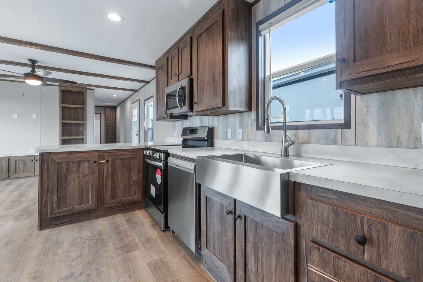 The ANNIVERSARY 16683B Kitchen. This Manufactured Mobile Home features 3 bedrooms and 2 baths.