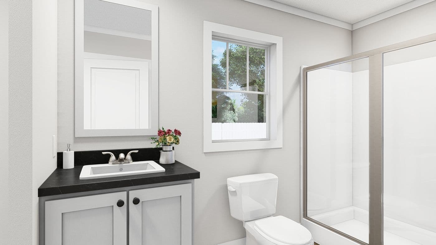 The MOVE ON UP Primary Bathroom. This Manufactured Mobile Home features 3 bedrooms and 2 baths.