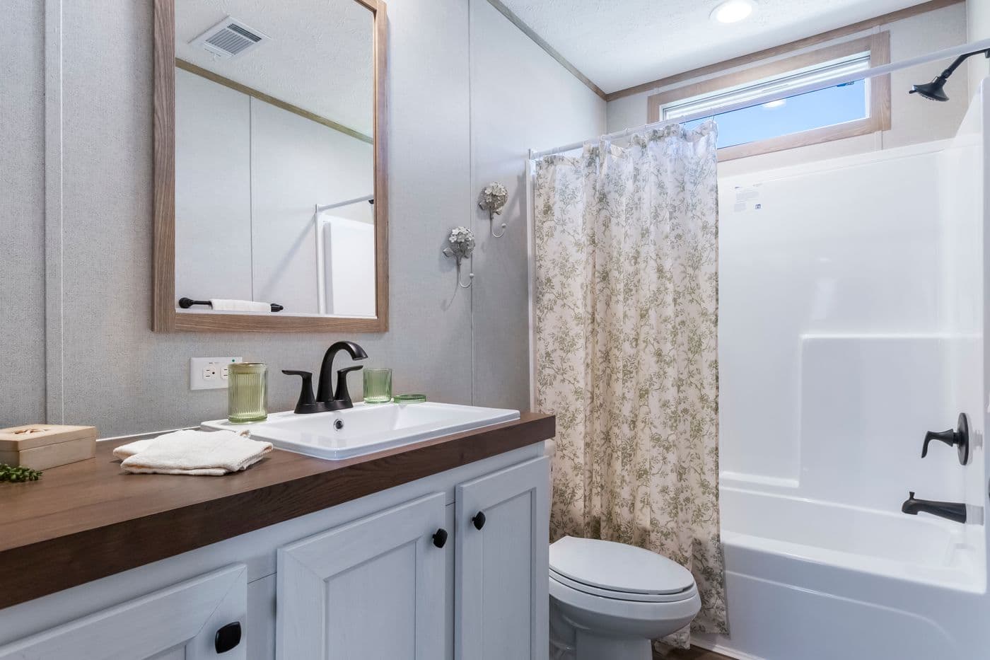 The THE BIG DEAL 52 Guest Bathroom. This Manufactured Mobile Home features 3 bedrooms and 2 baths.