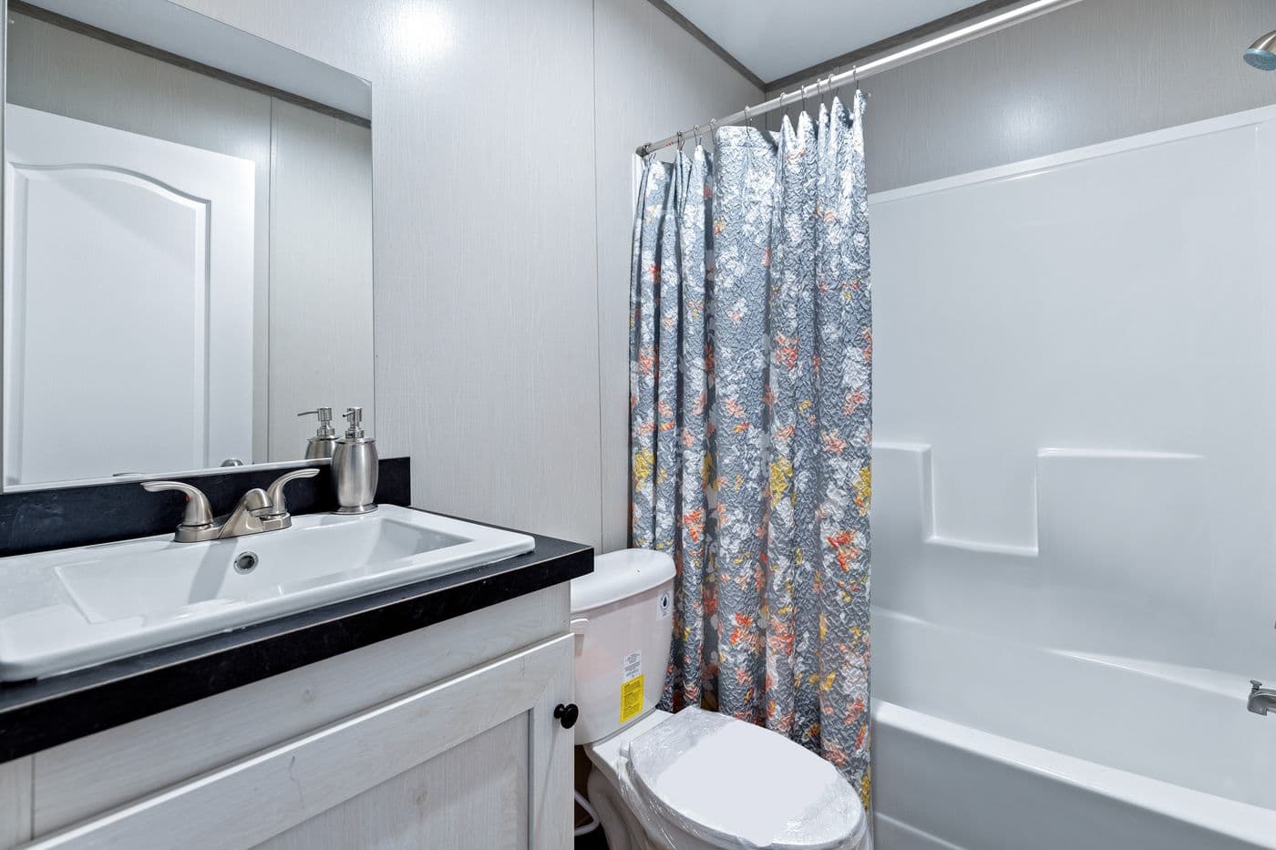 The RESOLUTION 16763J Guest Bathroom. This Manufactured Mobile Home features 3 bedrooms and 2 baths.