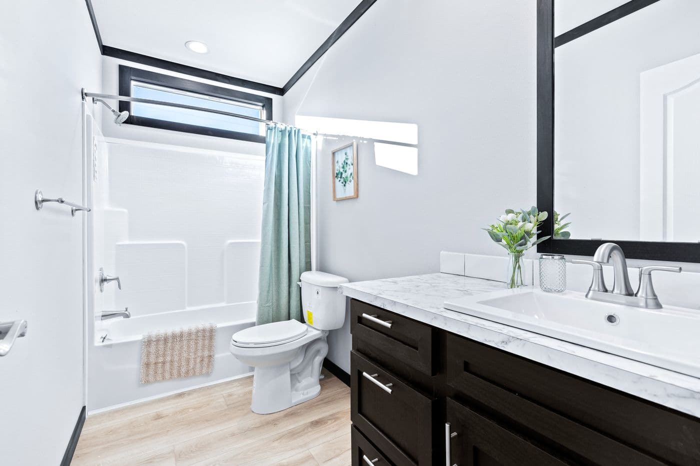 The THE LOUIS Guest Bathroom. This Manufactured Mobile Home features 4 bedrooms and 3 baths.