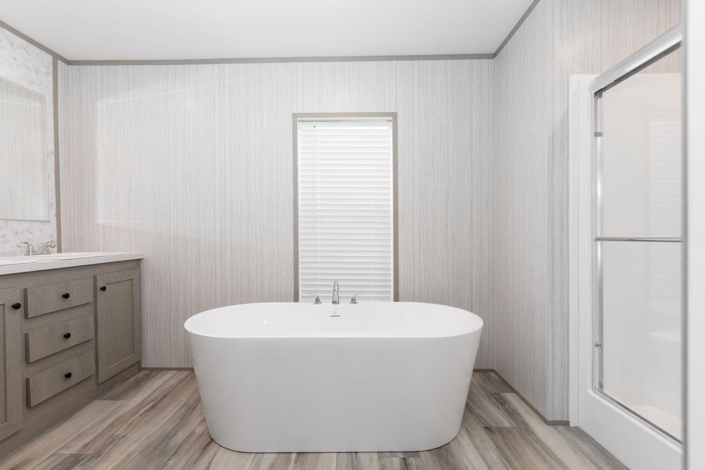 The THE OLYMPUS Primary Bathroom. This Manufactured Mobile Home features 3 bedrooms and 2 baths.