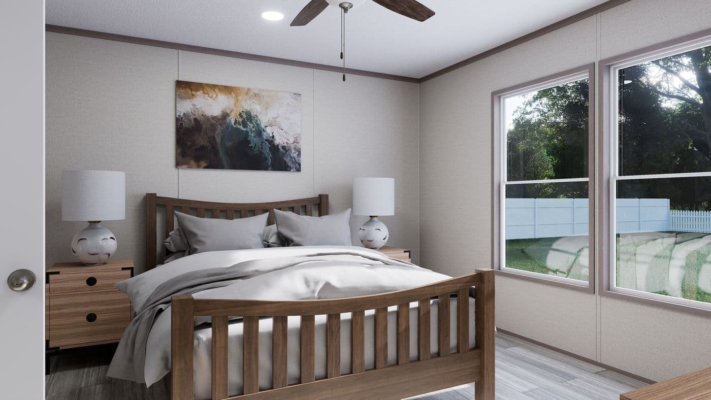 The THE MOUNTAINEER 60 Primary Bedroom. This Manufactured Mobile Home features 3 bedrooms and 2 baths.