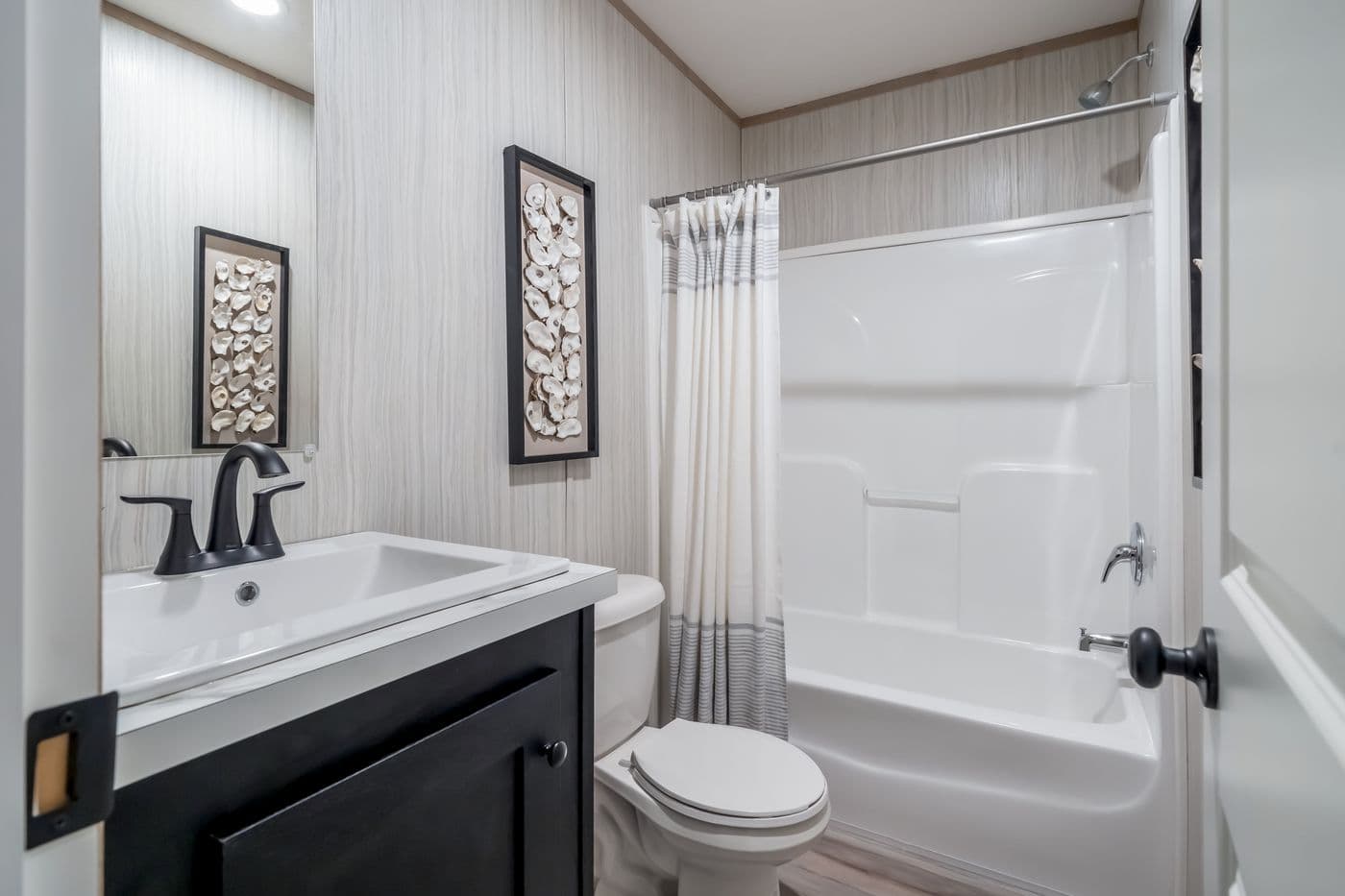 The ANNIVERSARY JEWEL Guest Bathroom. This Manufactured Mobile Home features 3 bedrooms and 2 baths.