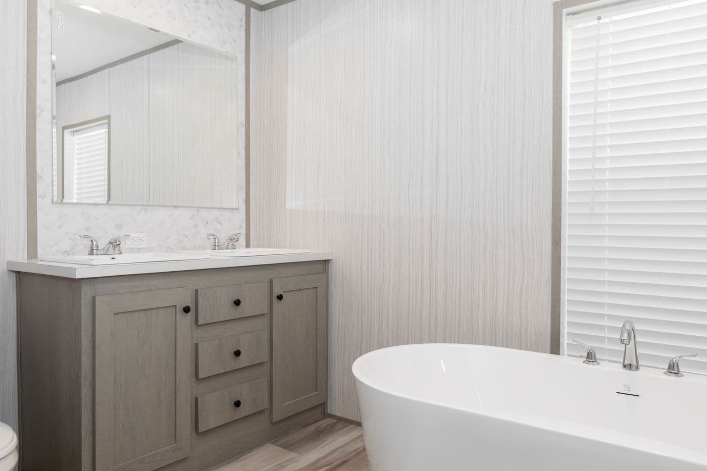 The THE OLYMPUS Primary Bathroom. This Manufactured Mobile Home features 3 bedrooms and 2 baths.