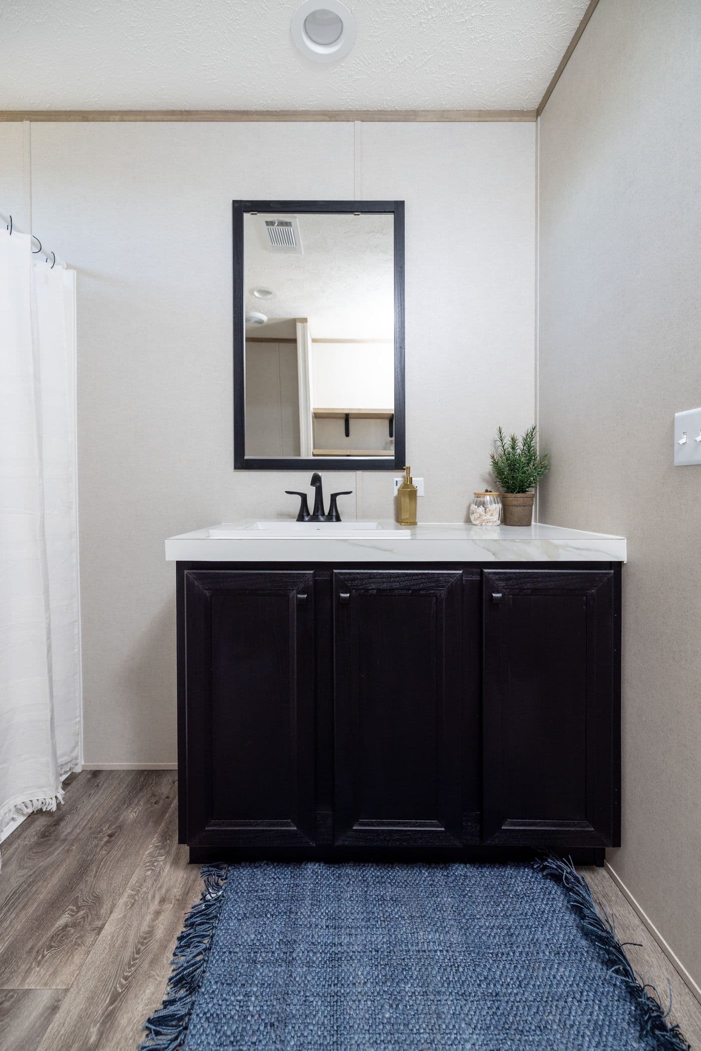 The STERLING ANNIVERSARY Guest Bathroom. This Manufactured Mobile Home features 3 bedrooms and 2 baths.