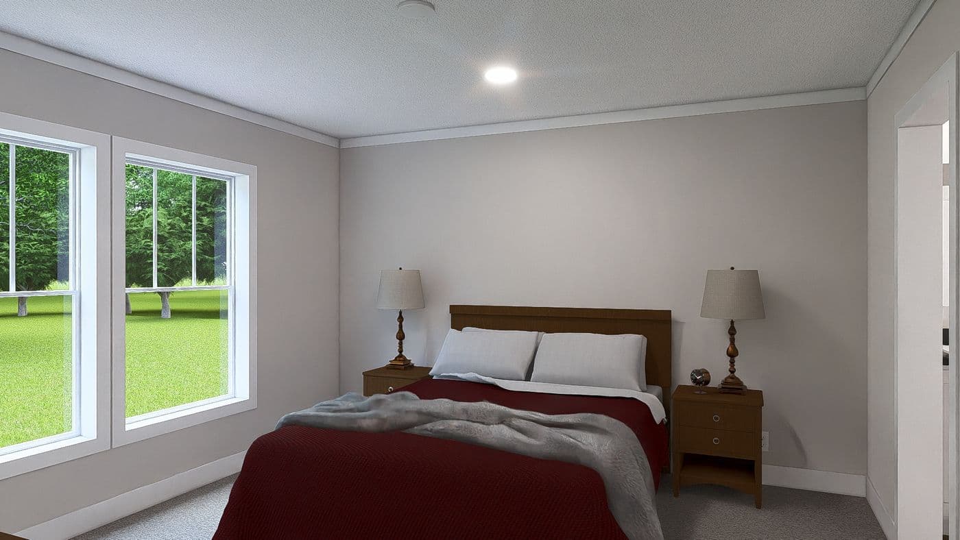 The LET IT BE Primary Bedroom. This Manufactured Mobile Home features 3 bedrooms and 2 baths.