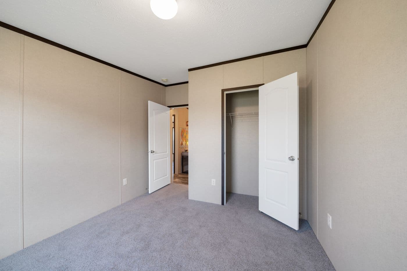The GARNET Guest Bedroom. This Manufactured Mobile Home features 3 bedrooms and 2 baths.