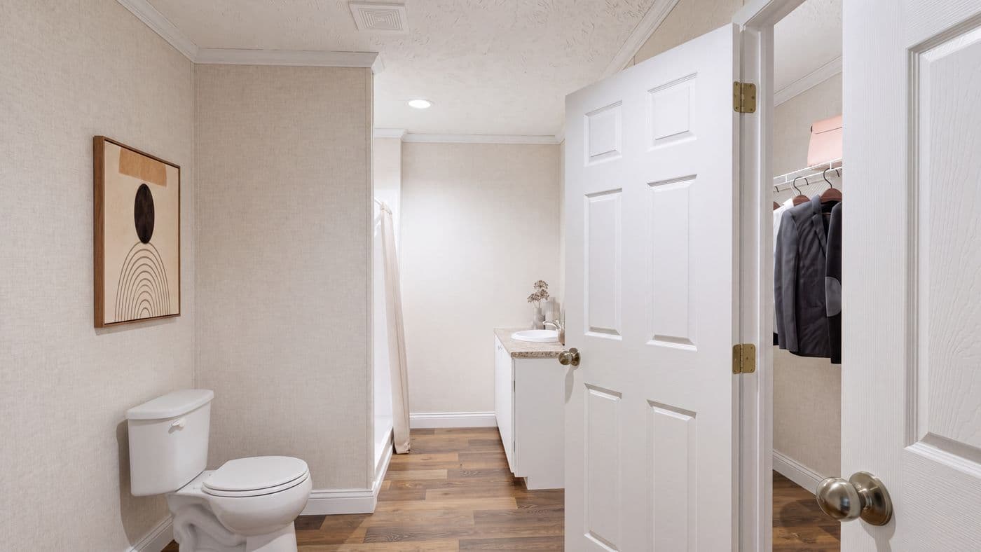 The REDWOOD Primary Bathroom. This Manufactured Mobile Home features 5 bedrooms and 3 baths.