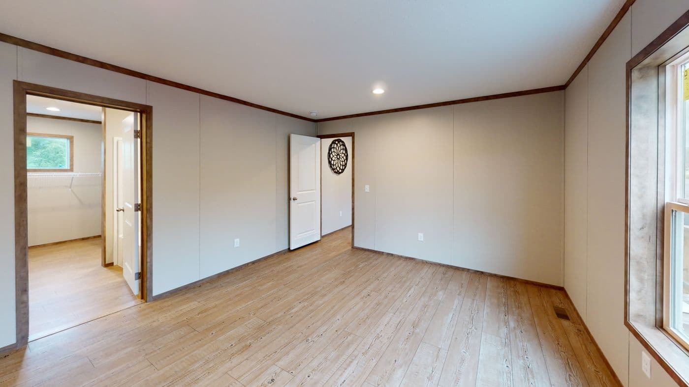 The BOONE Primary Bedroom. This Manufactured Mobile Home features 4 bedrooms and 2 baths.