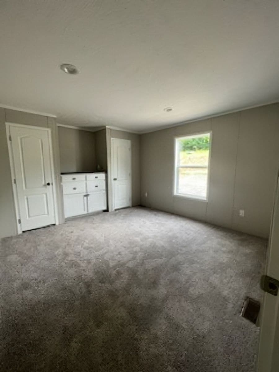 The JADE 40 Primary Bedroom. This Manufactured Mobile Home features 2 bedrooms and 2 baths.