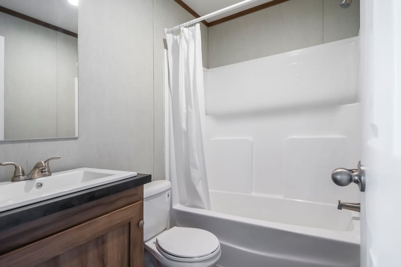 The SEAS THE DAY Guest Bathroom. This Manufactured Mobile Home features 3 bedrooms and 2 baths.