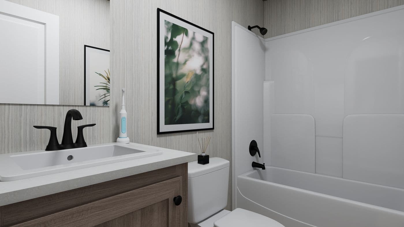The THE ANNIVERSARY 76 Guest Bathroom. This Manufactured Mobile Home features 3 bedrooms and 2 baths.