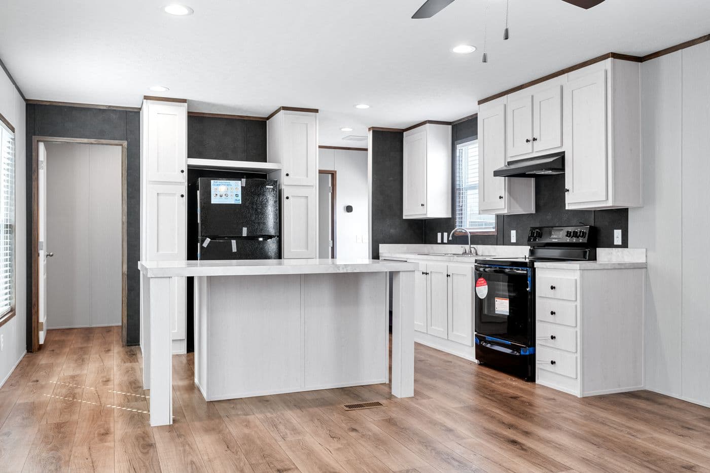 The HOMESTEAD 16602A Kitchen. This Manufactured Mobile Home features 2 bedrooms and 2 baths.