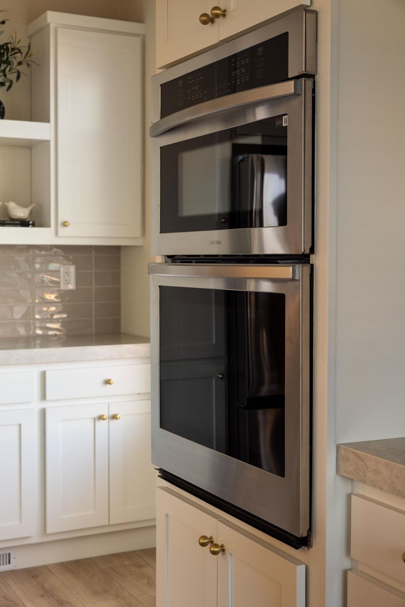 The ELEANOR Kitchen. This modern manufactured home features an elevated kitchen with an island, built-in oven, and gas range. 