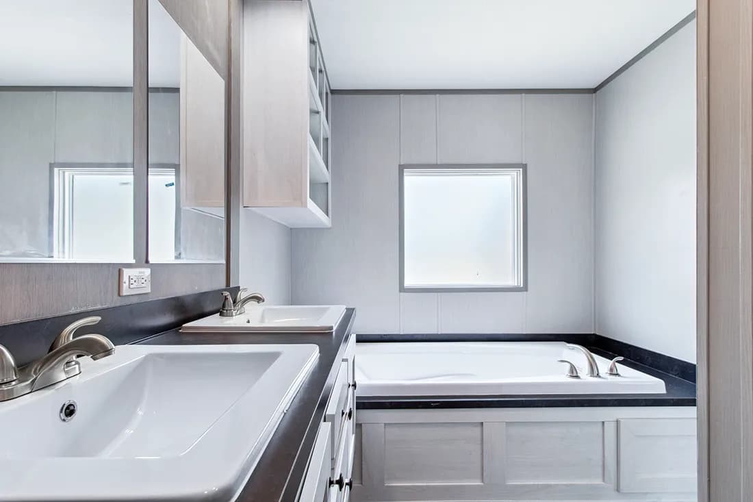 The ANNIVERSARY 16682F Primary Bathroom. This Manufactured Mobile Home features 2 bedrooms and 2 baths.
