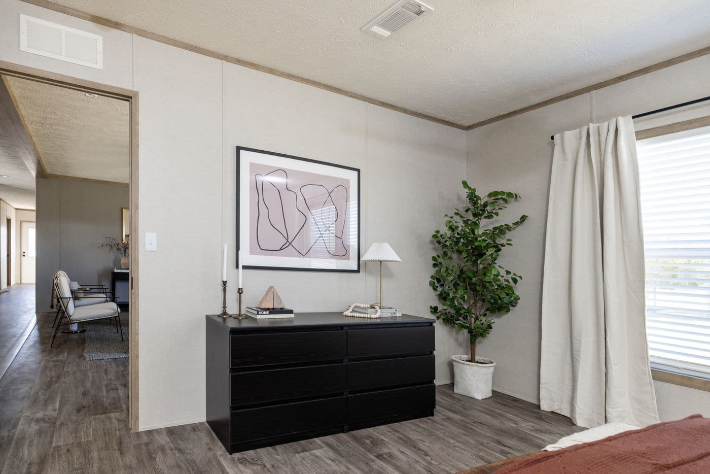 The STERLING ANNIVERSARY Primary Bedroom. This Manufactured Mobile Home features 3 bedrooms and 2 baths.
