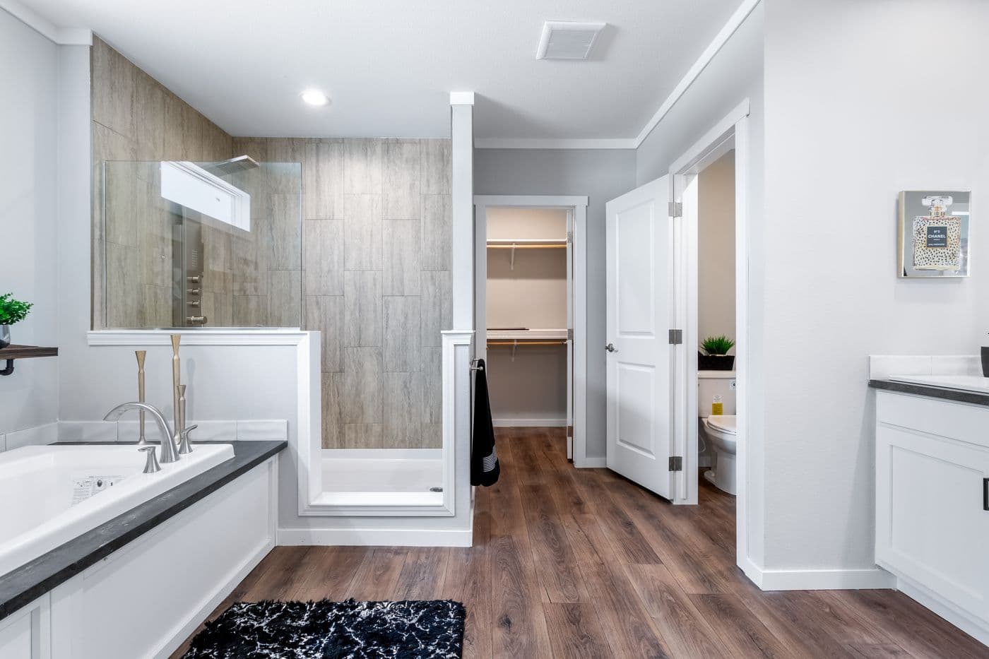 The THE CHANEL Primary Bathroom. This Manufactured Mobile Home features 4 bedrooms and 3 baths.