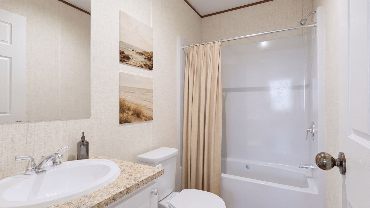 The SPRUCE Guest Bathroom. This Manufactured Mobile Home features 3 bedrooms and 2 baths.