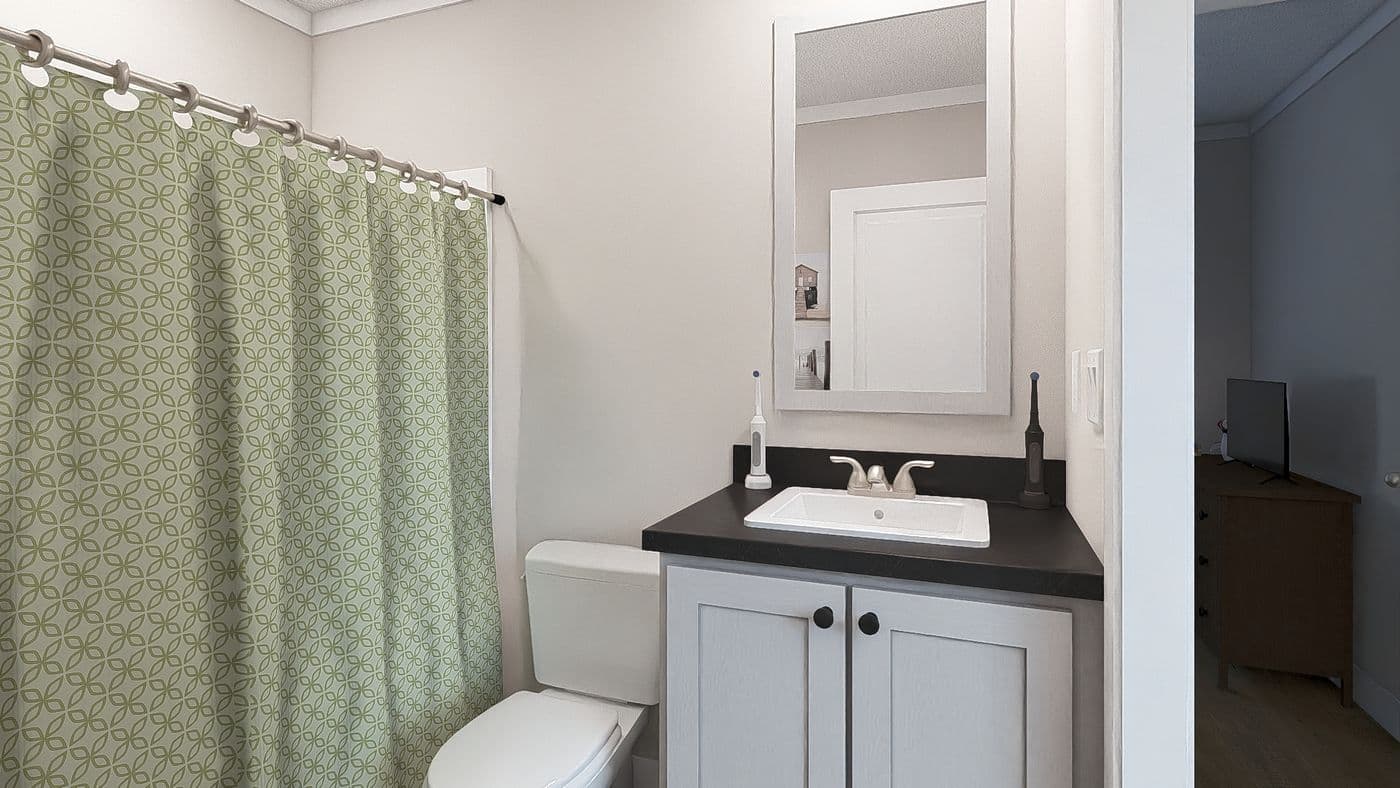 The RHYTHM NATION Guest Bathroom. This Manufactured Mobile Home features 3 bedrooms and 2 baths.