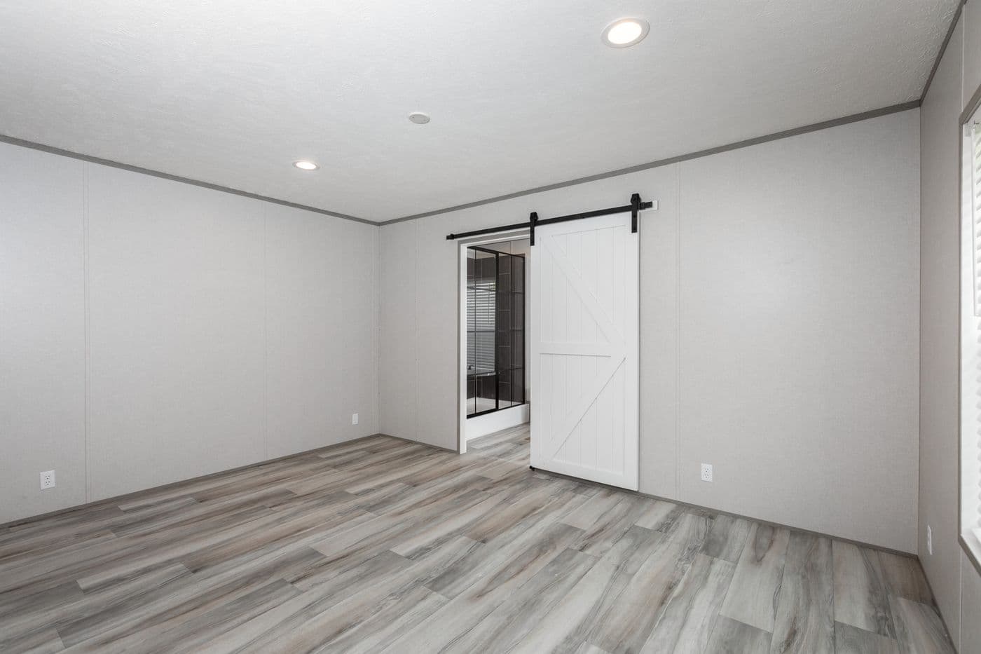The PLATINUM ANNIVERSARY Primary Bedroom. This Manufactured Mobile Home features 3 bedrooms and 2 baths.