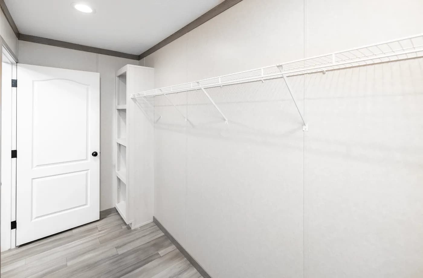 The 6428-E792 THE PULSE Primary Bedroom. This Manufactured Mobile Home features 3 bedrooms and 2.5 baths.