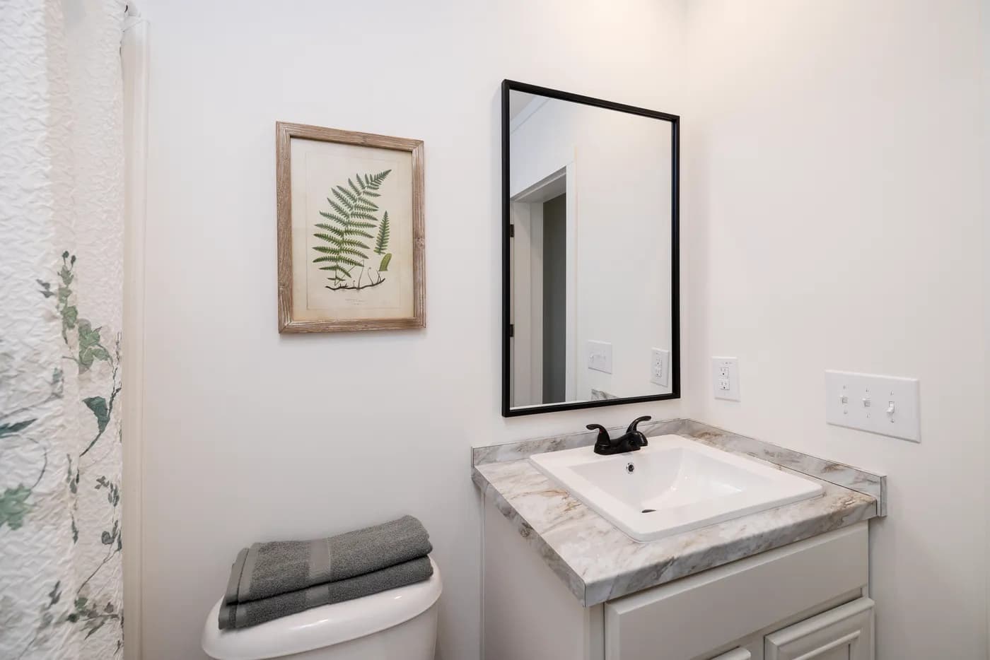 The THE ANNA FAE Guest Bathroom. This Manufactured Mobile Home features 3 bedrooms and 2 baths.