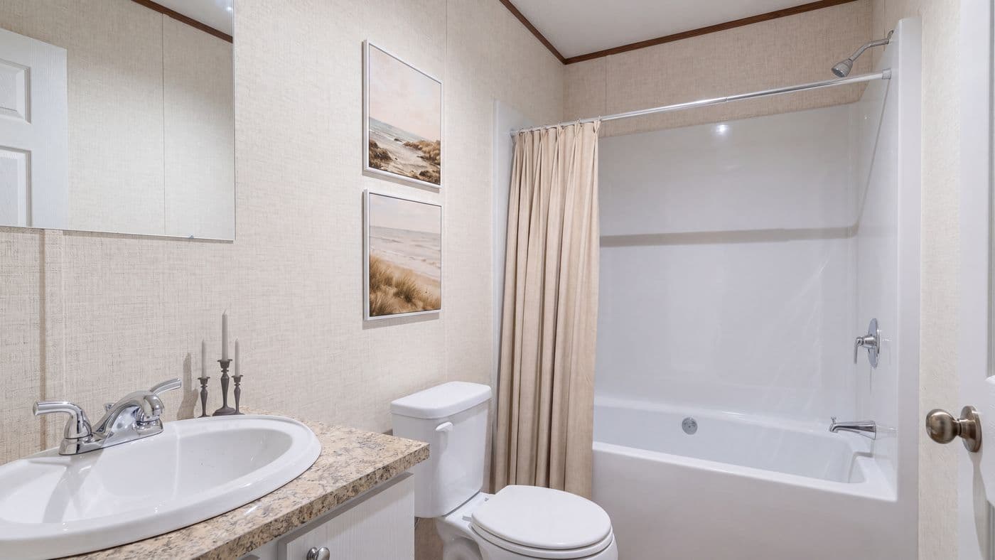 The REDWOOD Guest Bathroom. This Manufactured Mobile Home features 5 bedrooms and 3 baths.