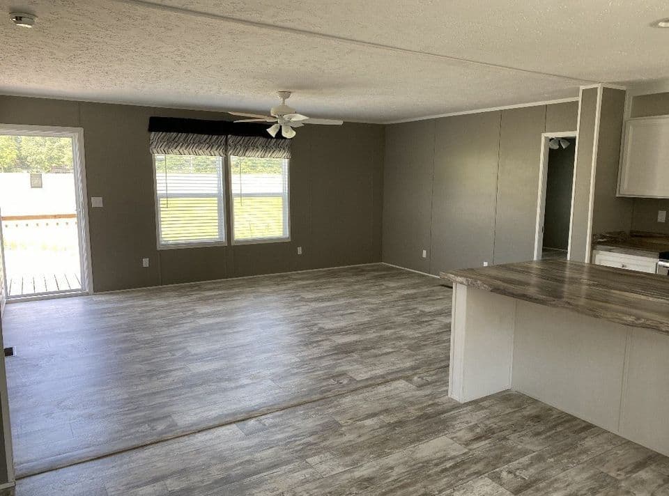 Enjoy an inviting open-concept living space with a stylish eat-at bar, perfect for casual dining and entertaining!