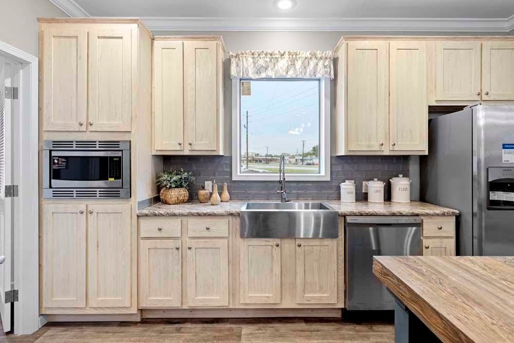 The THE TILLEY Kitchen. This Manufactured Mobile Home features 3 bedrooms and 2 baths.