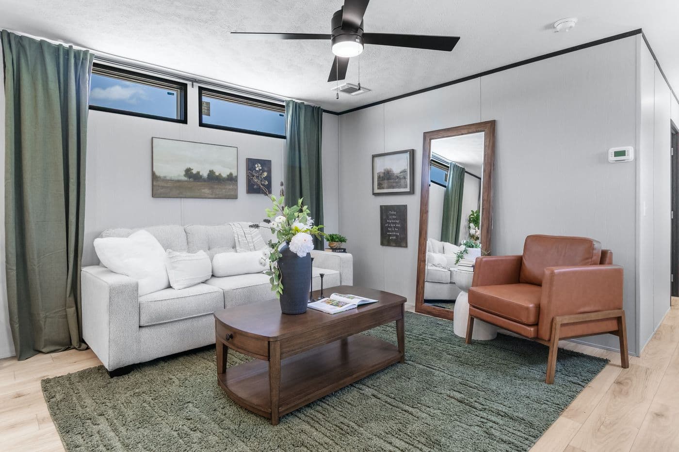 The RESOLUTION 16803B Living Room. This Manufactured Mobile Home features 3 bedrooms and 2 baths.