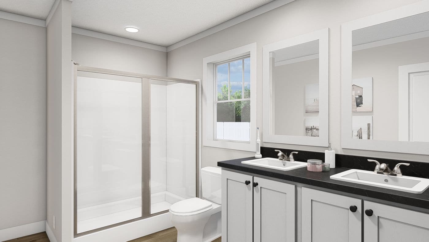 The THREE LITTLE BIRDS Primary Bathroom. This Manufactured Mobile Home features 3 bedrooms and 2 baths.