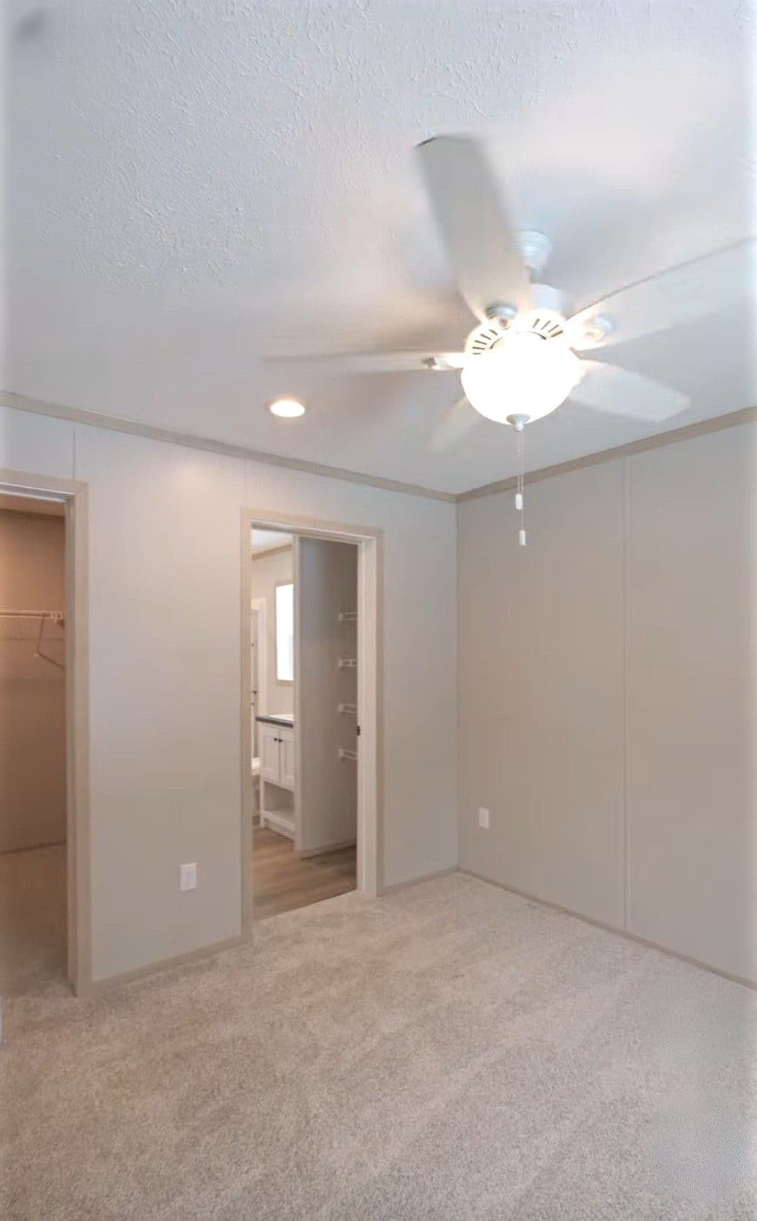 The TURQUOISE Primary Bedroom. This Manufactured Mobile Home features 2 bedrooms and 2 baths.