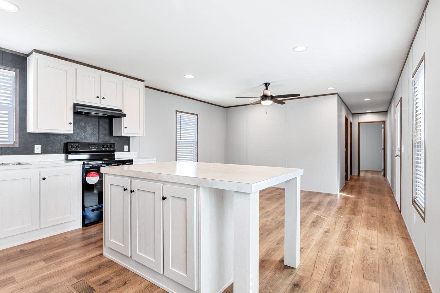 The HOMESTEAD 16683A Kitchen. This Manufactured Mobile Home features 3 bedrooms and 2 baths.