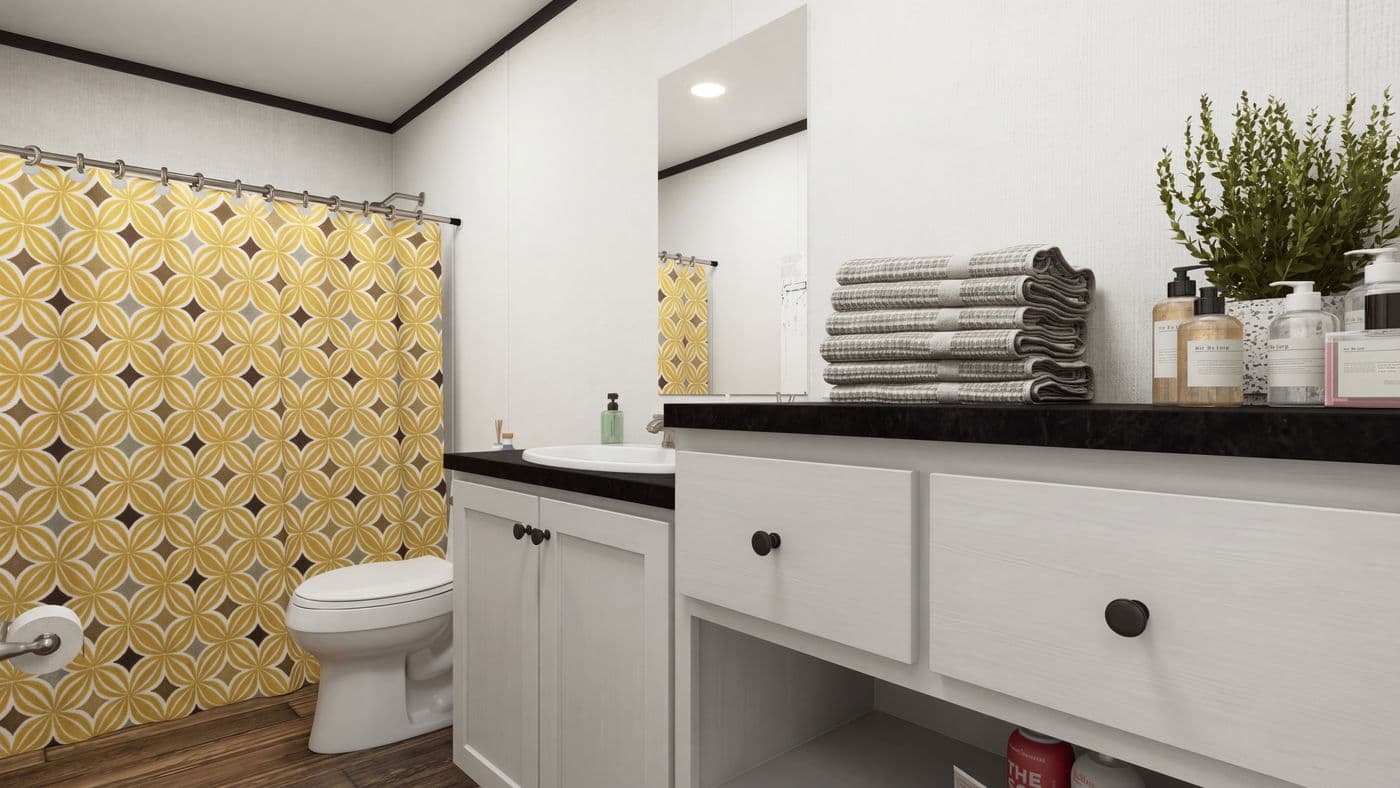 The THE MOUNTAINEER 56 Guest Bathroom. This Manufactured Mobile Home features 3 bedrooms and 2 baths.