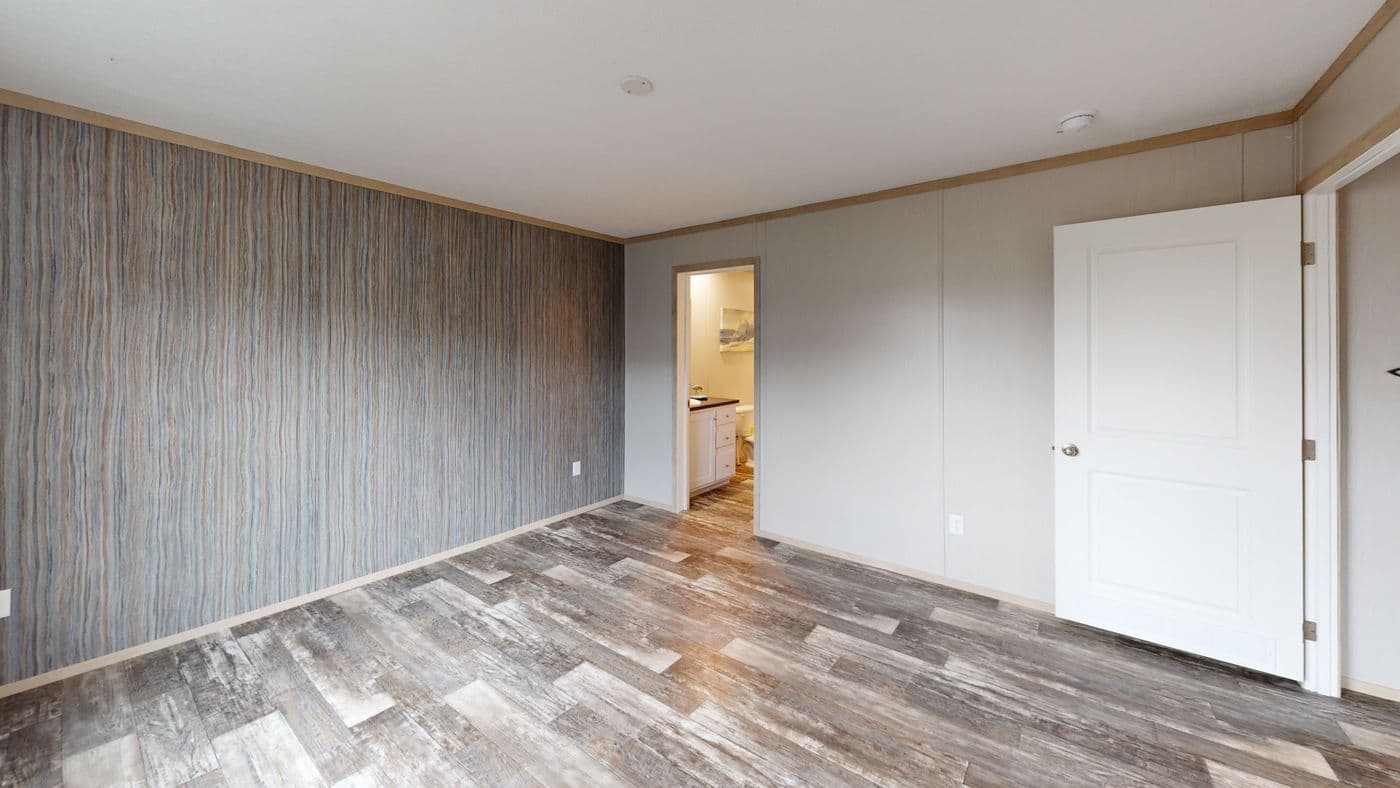 The HANCOCK Primary Bedroom. This Manufactured Mobile Home features 4 bedrooms and 2 baths.