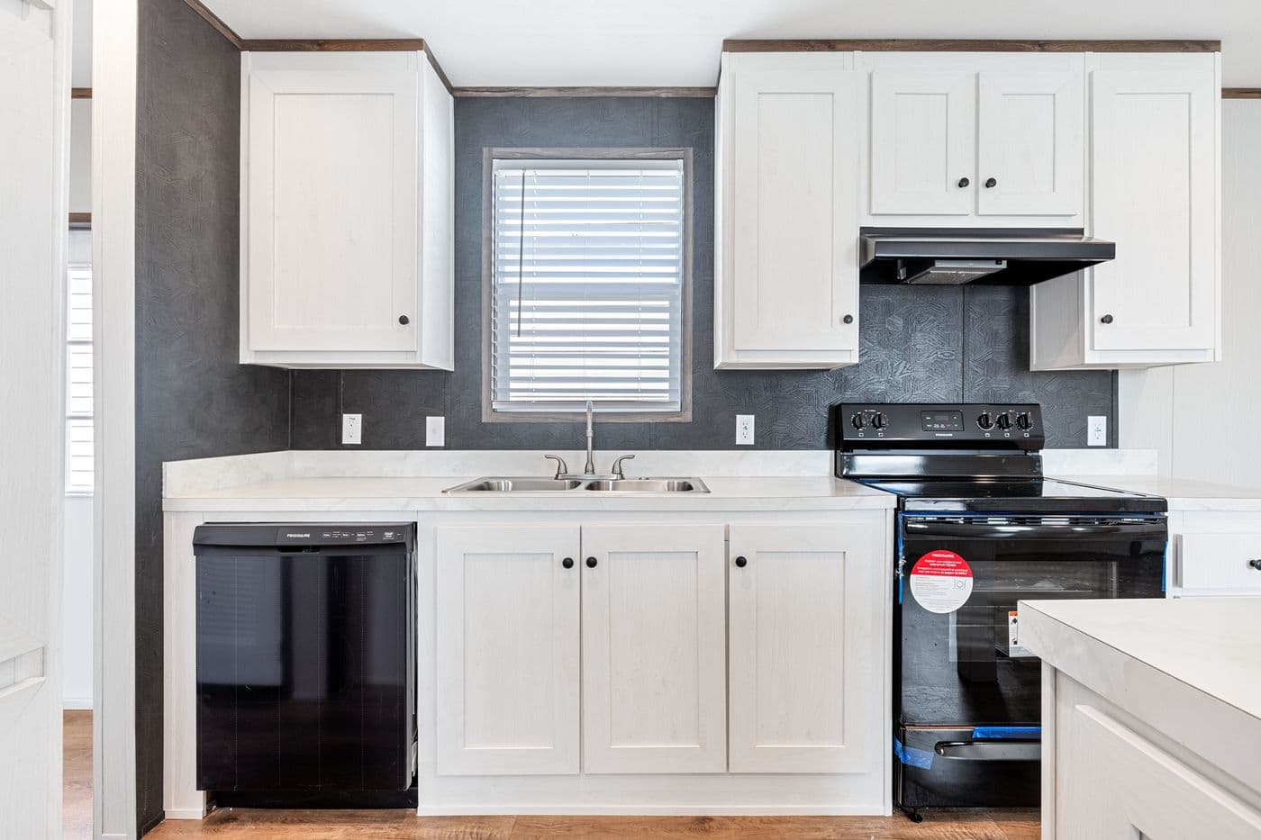 The HOMESTEAD 16683A Kitchen. This Manufactured Mobile Home features 3 bedrooms and 2 baths.