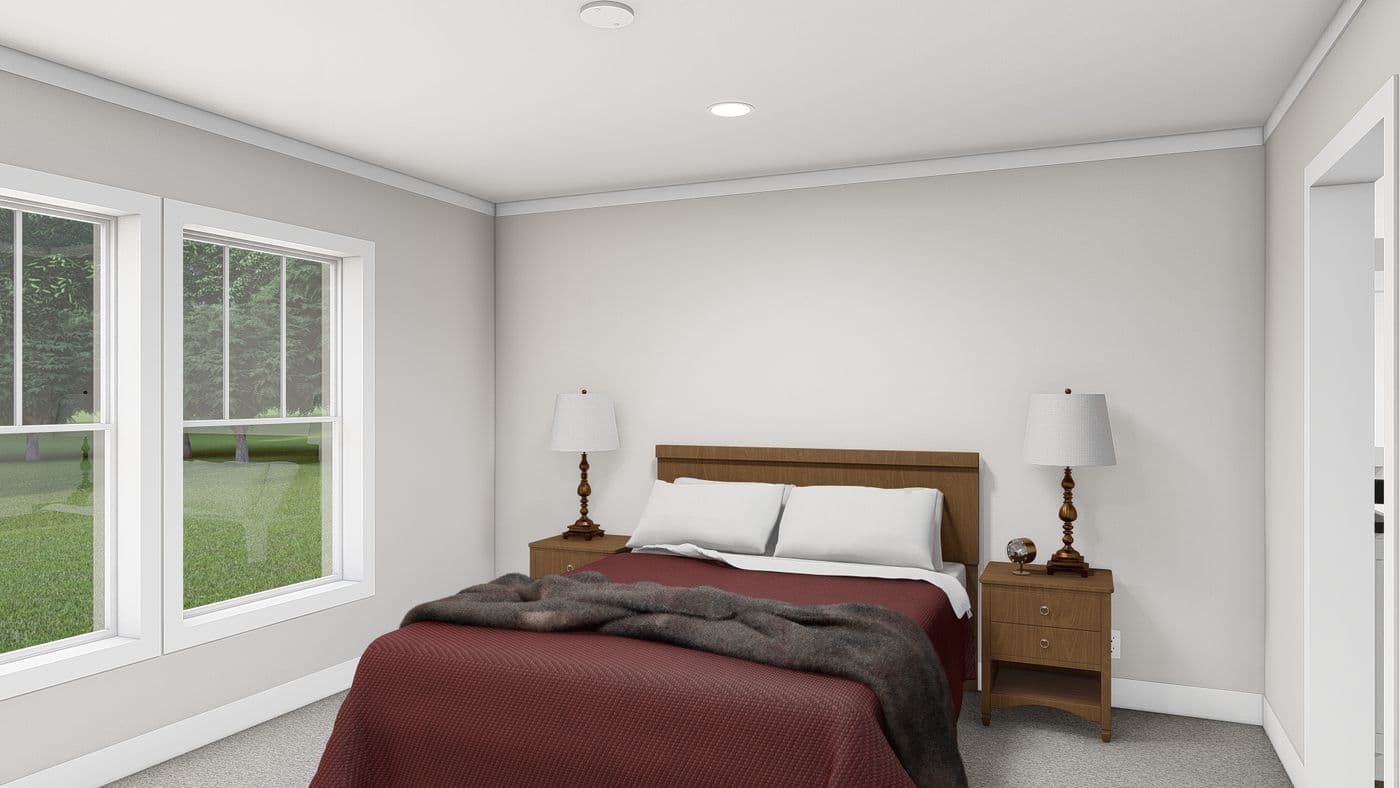 The LET IT BE Primary Bedroom. This Manufactured Mobile Home features 3 bedrooms and 2 baths.