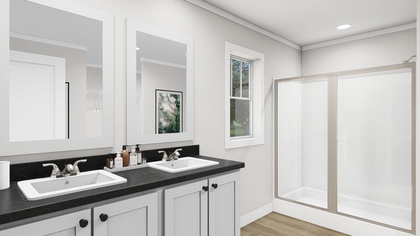 The LET IT BE Primary Bathroom. This Manufactured Mobile Home features 3 bedrooms and 2 baths.