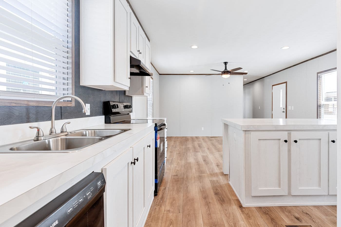 The HOMESTEAD 16683A Kitchen. This Manufactured Mobile Home features 3 bedrooms and 2 baths.