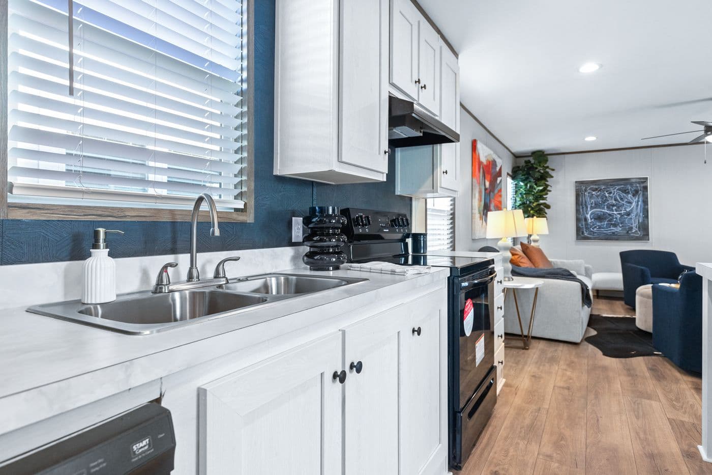 The HOMESTEAD 16763A Kitchen. This Manufactured Mobile Home features 3 bedrooms and 2 baths.