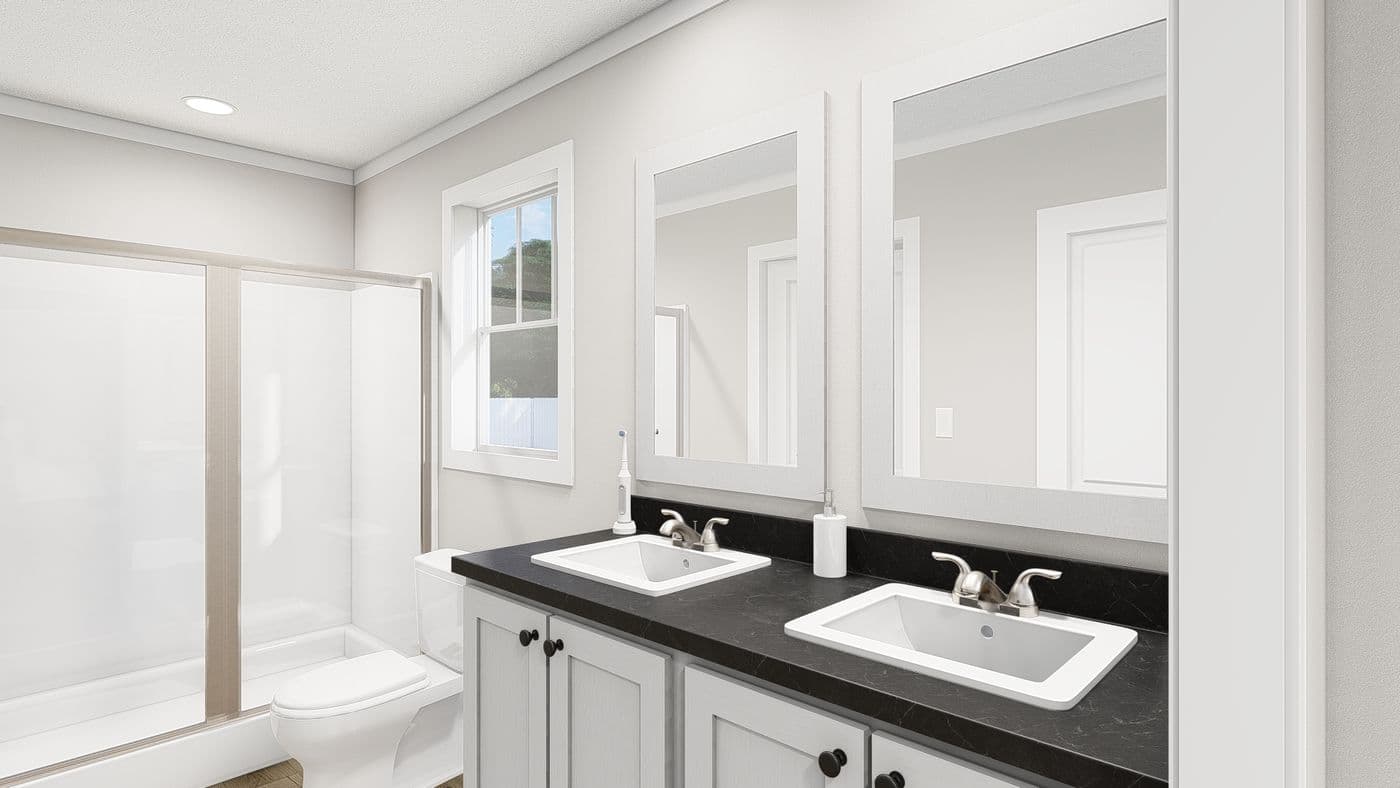 The HERE COMES THE SUN Primary Bathroom. This Manufactured Mobile Home features 3 bedrooms and 2 baths.